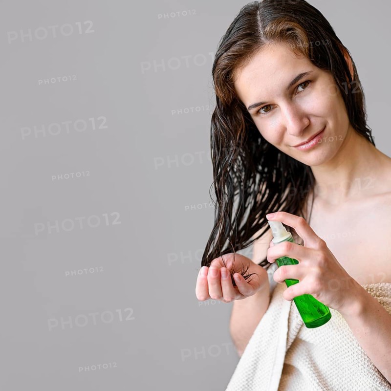 Portrait female using hair oil