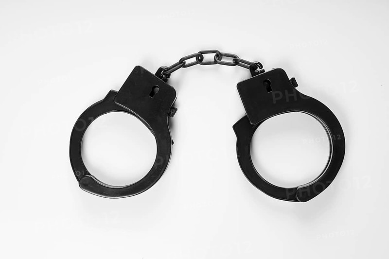 black plastic handcuffs sex toy on white background
