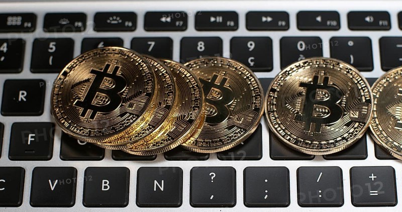 Bitcoins on Computer Keyboard Background