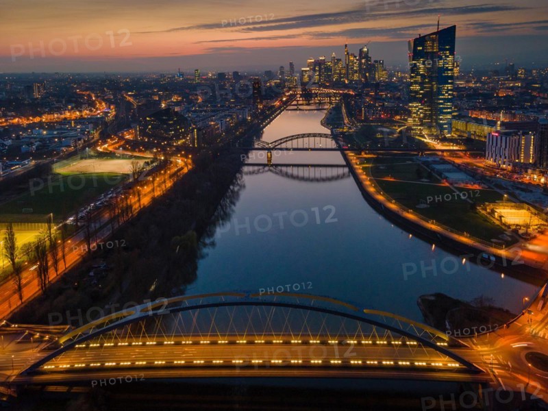 The lights of the European Central Bank (ECB) and the Frankfurt banking skyline glow in the evening. (Aerial view with a drone), Osthafen, Frankfurt am Main, Hesse, Germany, Europe