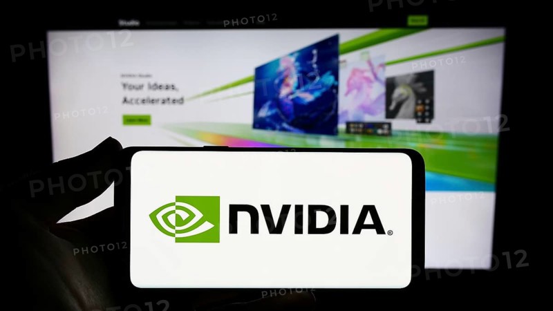 Stuttgart, Germany, 08-13-2023: Person holding smartphone with logo of US technology company Nvidia Corporation on screen in front of website. Focus on phone display, Europe