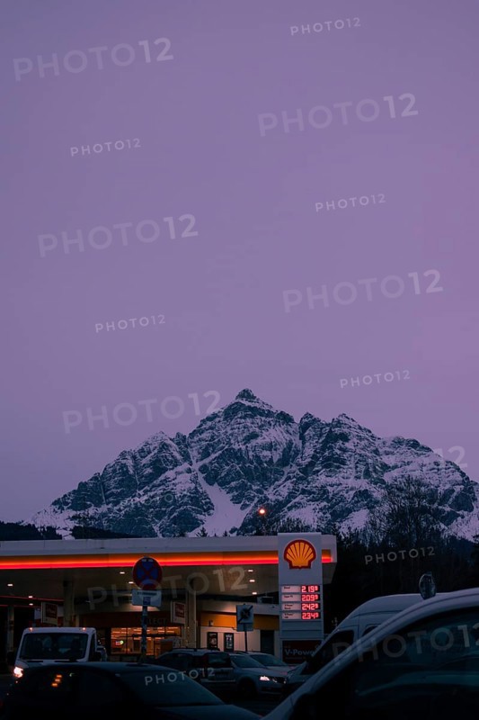 Shell petrol station in the foreground at dusk, snow-covered Serles mountain peaks in the background, Europabrücke bridge, Tyrol, Austria, Europe