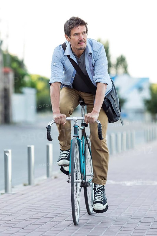 Portrait man riding bicycle city