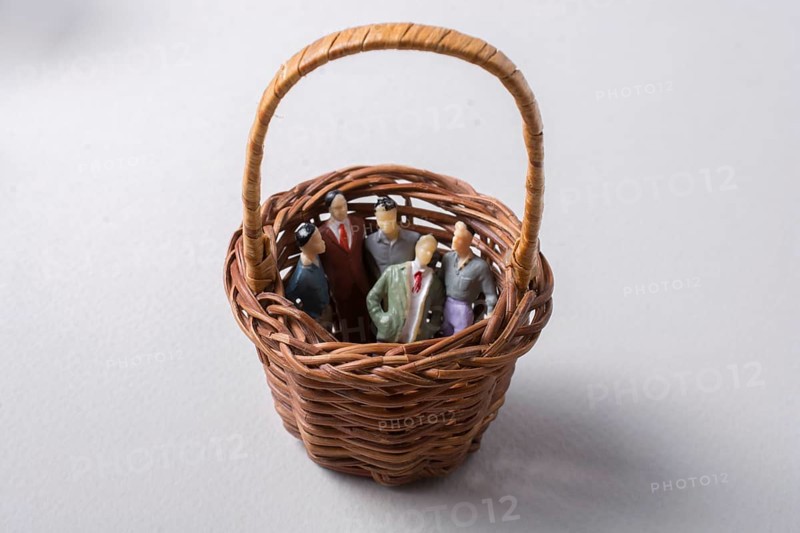 Tiny figurine of group of men miniature model in basket