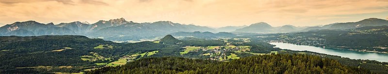 Panorama of Alpine mountains near Lake Worthersee and Velden city. Travel destination in Austria