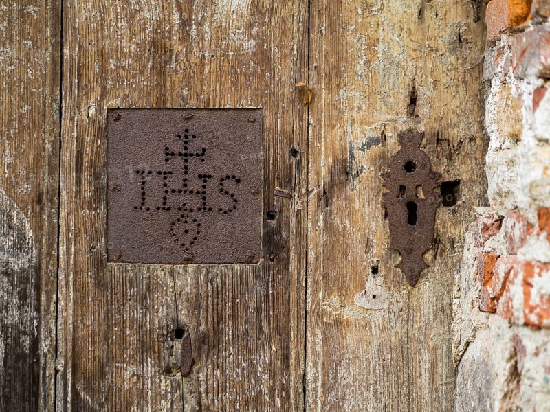 IHS, symbol of the Jesuits, detail of a gate, cemetery near the church of St. Jacob, Leoben, Styria, Austria, Europe