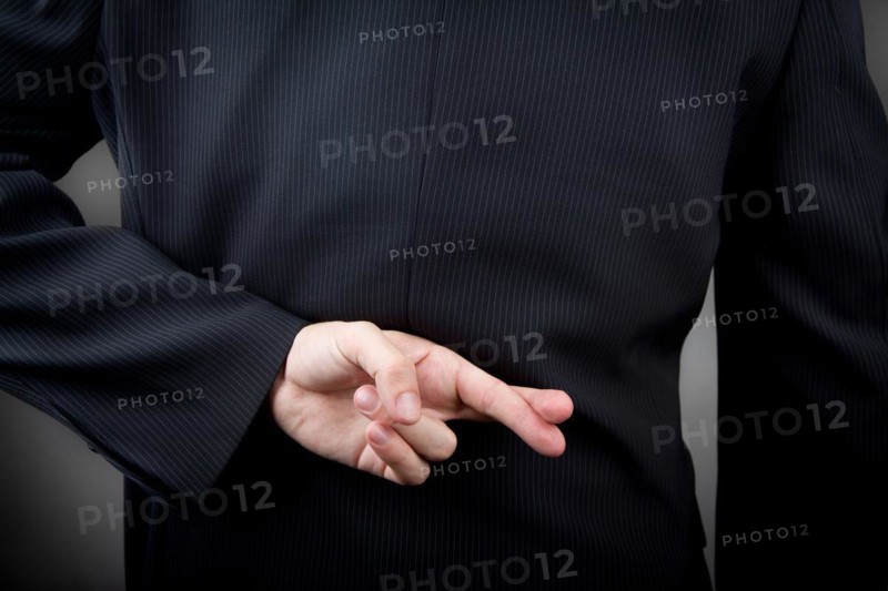 Crossed fingers behind the man's back