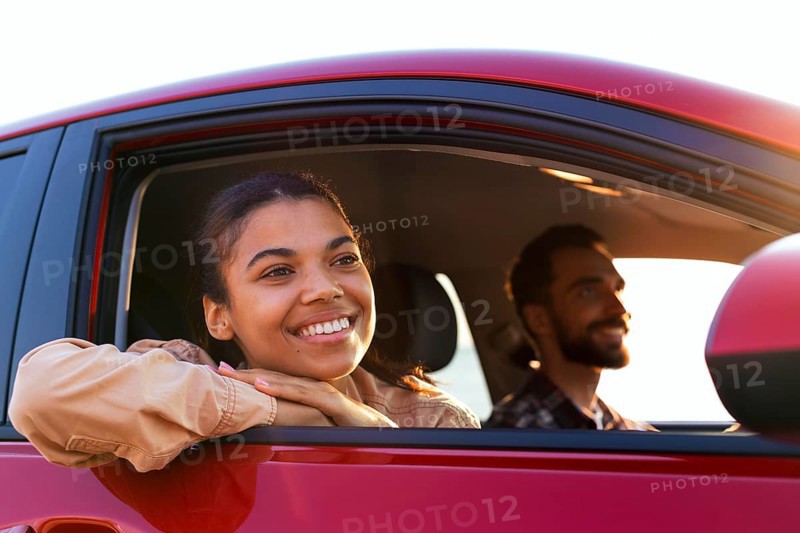 Smiley couple traveling by car