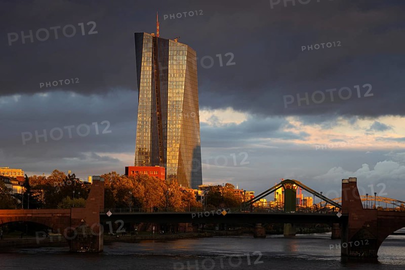 Dark clouds pass over the European Central Bank (ECB), illuminated by the last sunlight of the day, Frankfurt am Main, Hesse, Germany, Europe