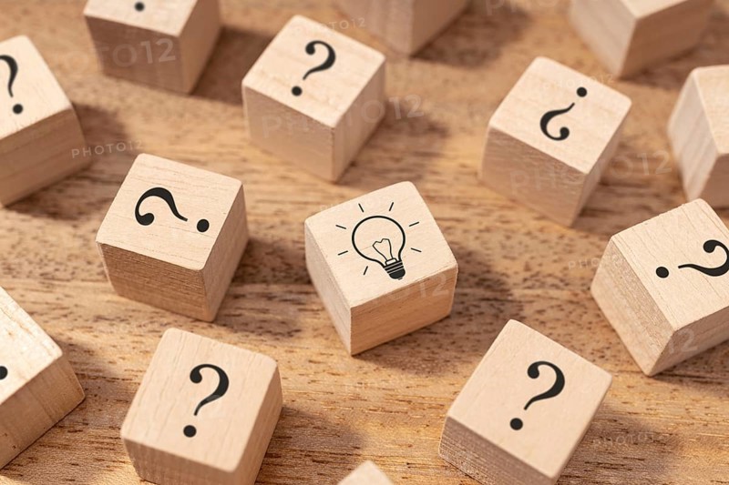 Creative idea and innovation concept. Wooden blocks with question mark symbol and light bulb
