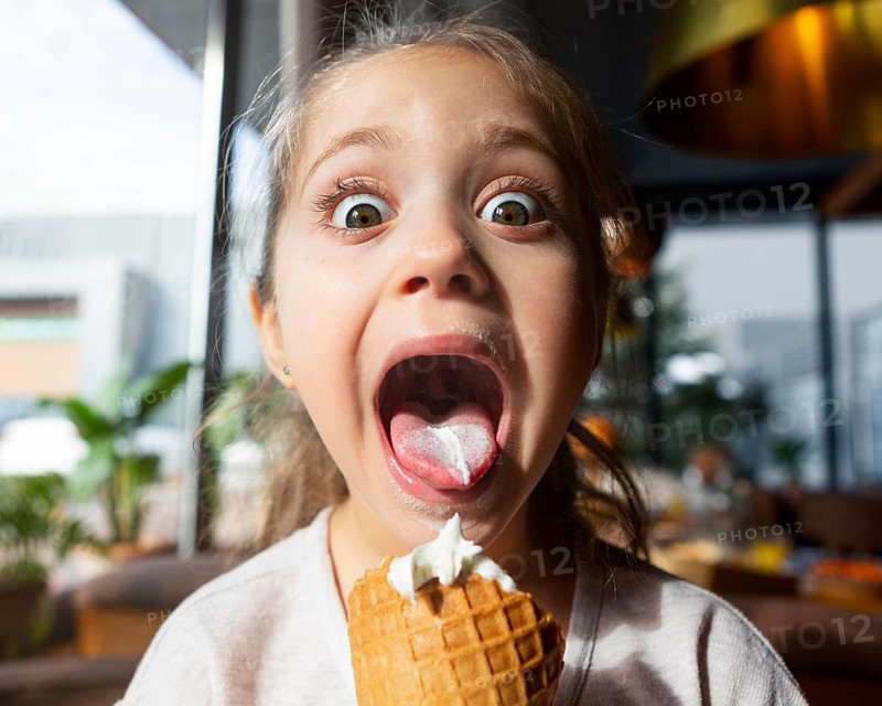 Surprised girl eating ice cream close up