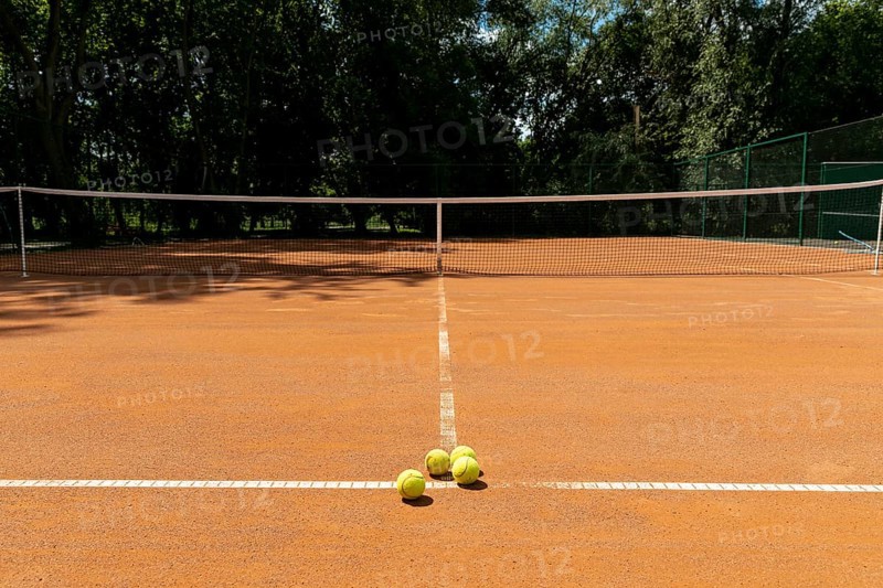 Tennis court with tennis balls ground