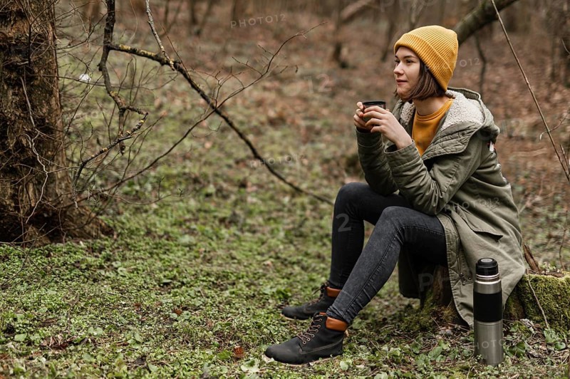 Full shot woman sitting grass