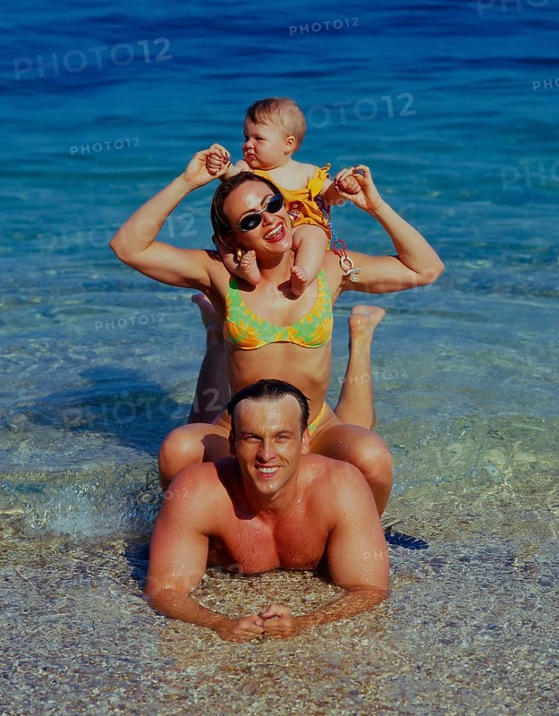 Family with baby on the beach/sea