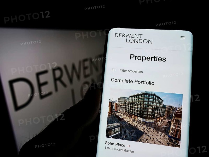 Stuttgart, Germany, 03-06-2022: Person holding cellphone with website of British real estate company Derwent London plc on screen with logo. Focus on center of phone display, Europe