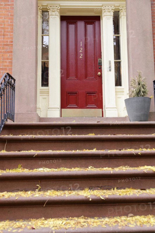 Red front door of a townhouse with steps and house number 122, Manhattan, New York City, New York, USA, North America
