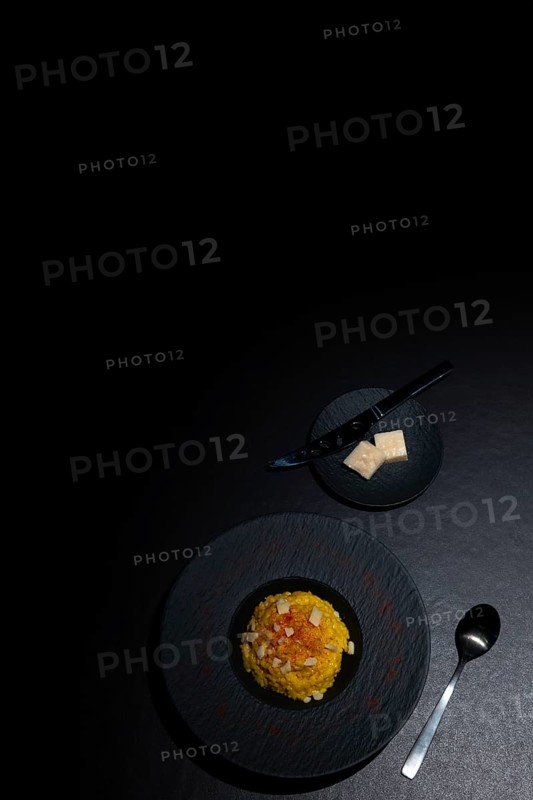 Elegant Plate with Risotto alla Milanese with Saffron and Parmesan Cheese in Lugano, Ticino, Switzerland, Europe