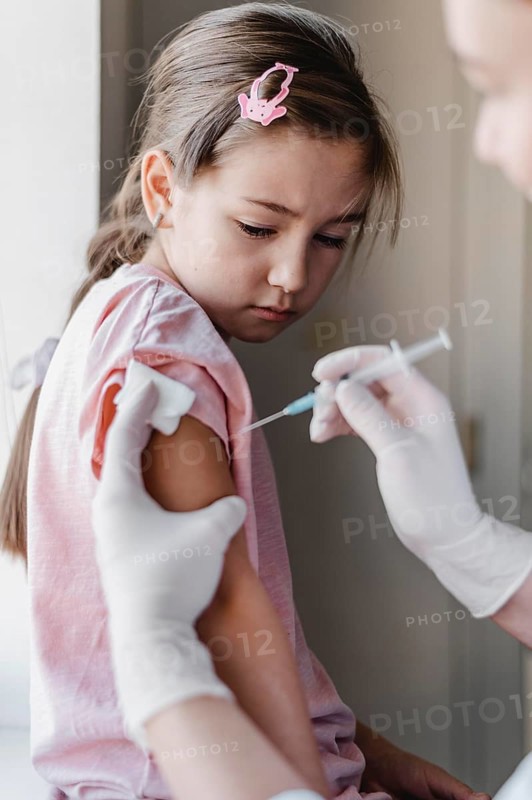 Little child with doctor getting vaccine