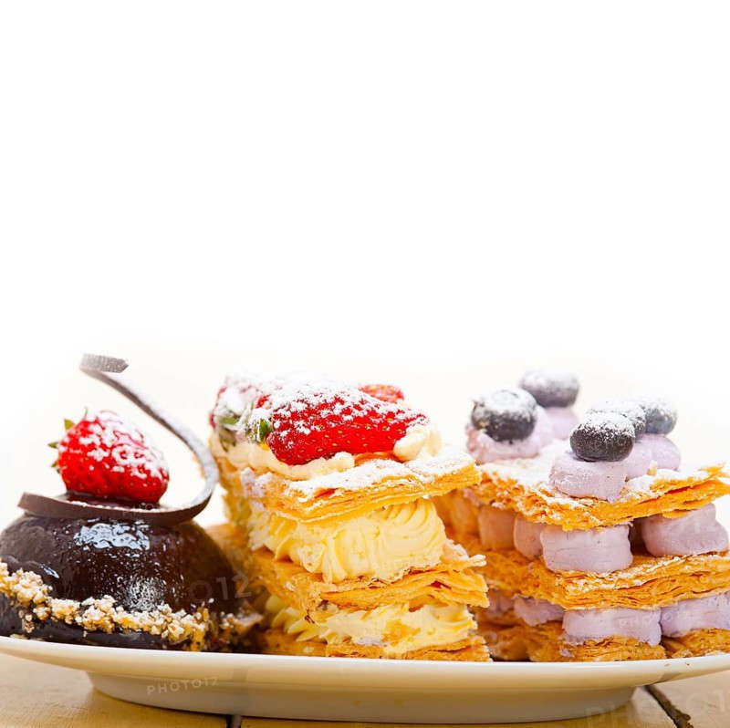 Selection of fresh cream napoleon and chocolate mousse cake dessert plate