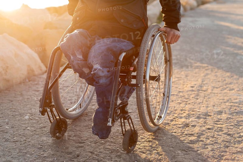 Close up man wheelchair beach