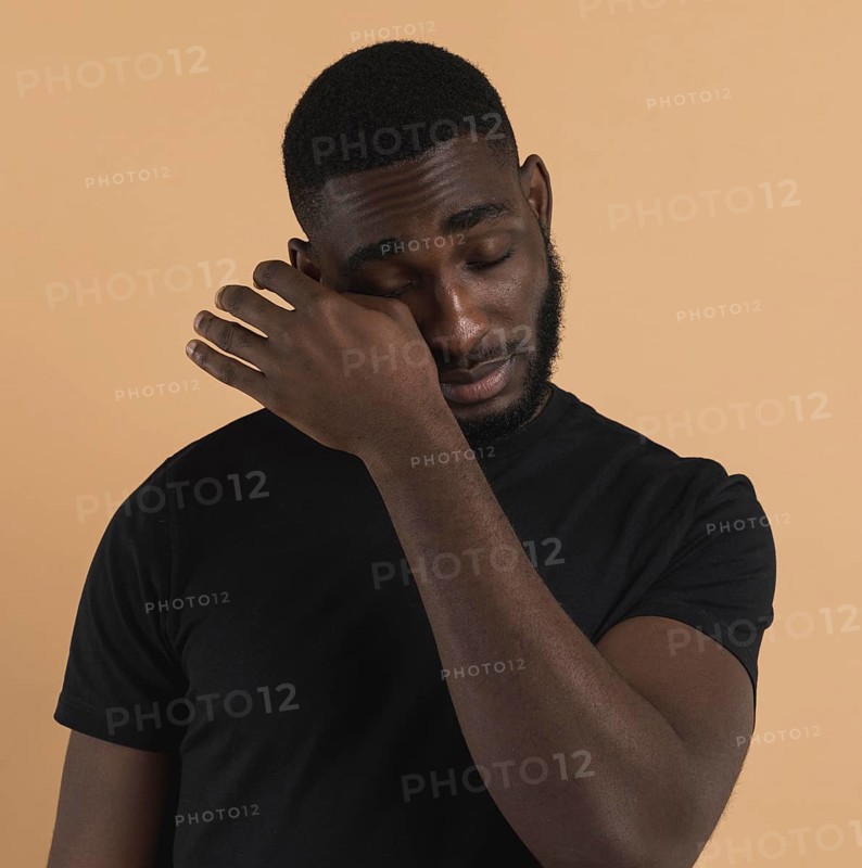 Person wiping away his tears