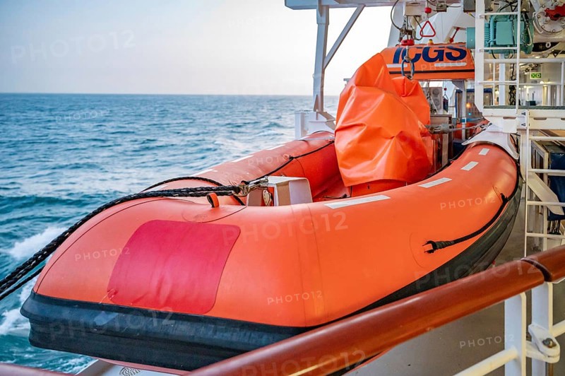 Orange AIDA Bella Cruise Ship lifeboat attached to the ship during sunset