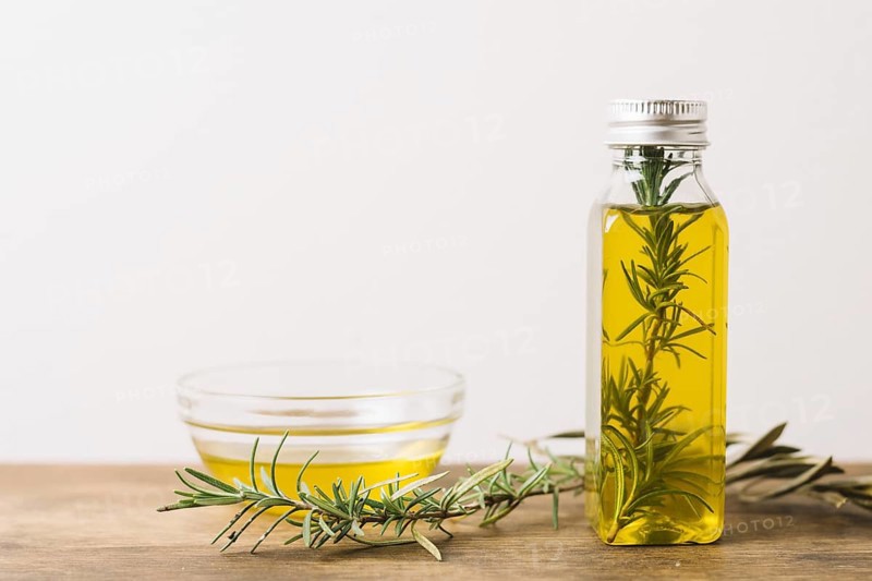 Horizontal shot olive oil with rosemary copy space