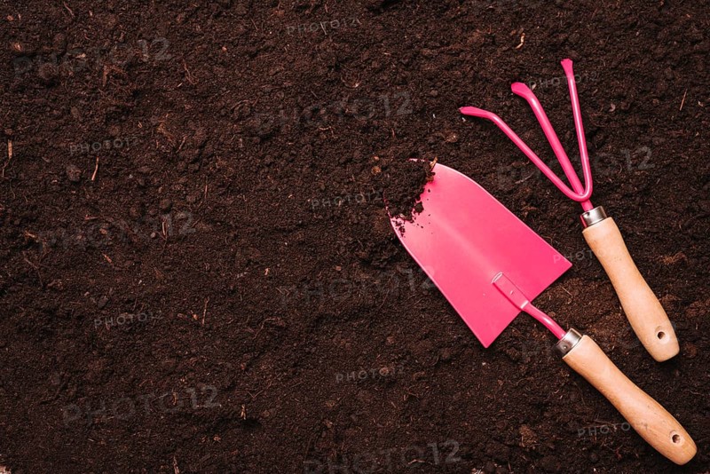 Gardening concept with shovel rake soil. High resolution photo