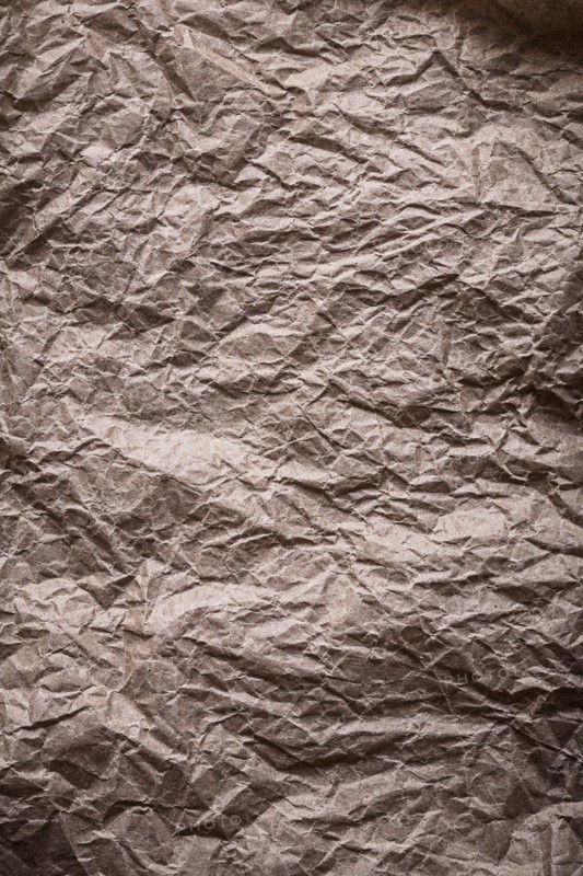 Ancient messy crumpled paper in vertical design