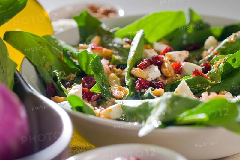 Plate of fresh colorfull spinach salad close up