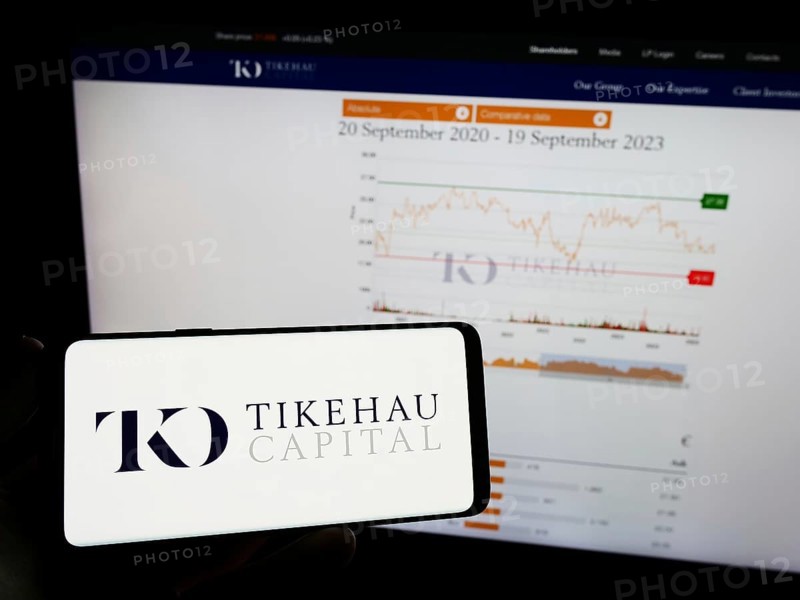 Stuttgart, Germany, 09-20-2023: Person holding mobile phone with logo of French investment company Tikehau Capital on screen in front of web page. Focus on phone display, Europe