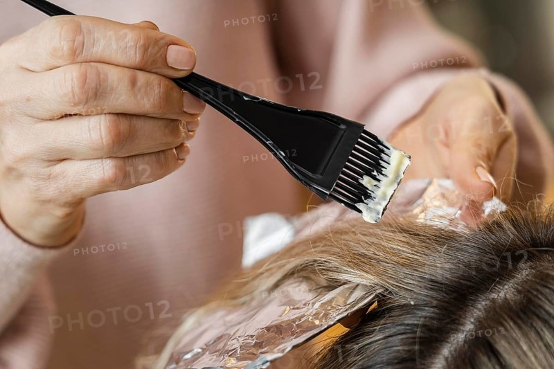 Woman getting her hair dyed home by beautician. Beautiful photo