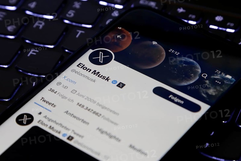 Symbolic image social media, close-up of a smartphone on illuminated computer keyboard with X logo on Elon Musk's account in the Twitter app, Germany, Europe