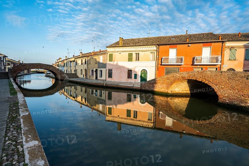 Houses and bridges reflected in the canal, Via Agatopisto Cromaciano, Comacchio, Emilia Romagna, Italy, Europe