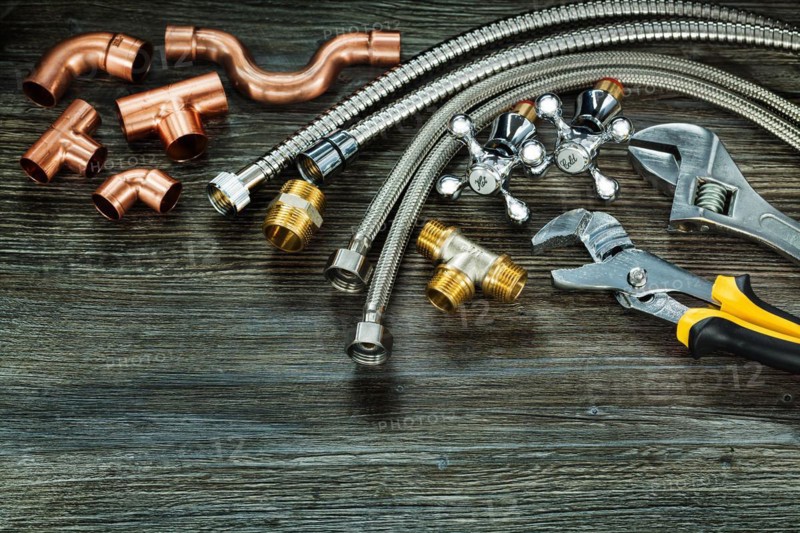 Chrome and copper plumbing accessories on vintage wood