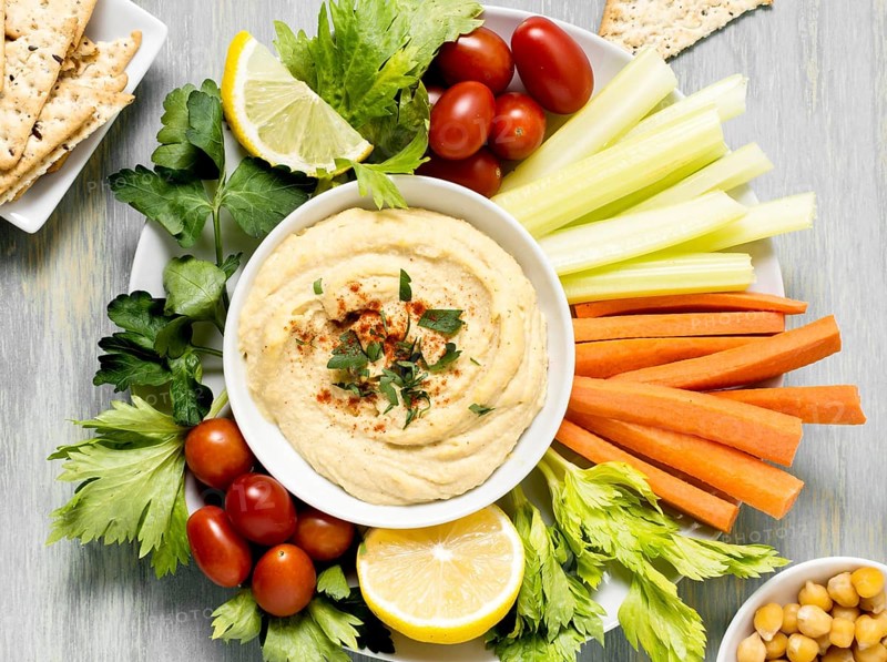 Top view hummus with assortment vegetables. Beautiful photo