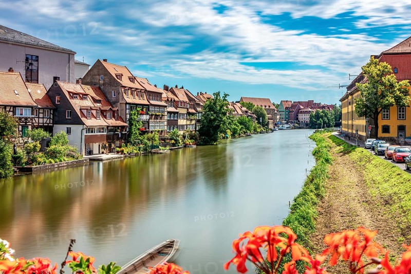 View of a quiet riverside town with traditional architecture and nature, Little Venice Bamberg seen from St Mark's Bridge