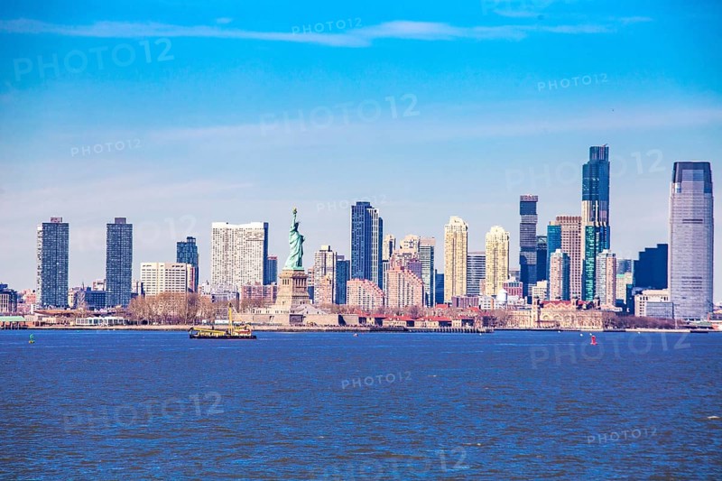Statue of Liberty Statue of Liberty and behind it skyline of New Jersey City, seen from New York Oat