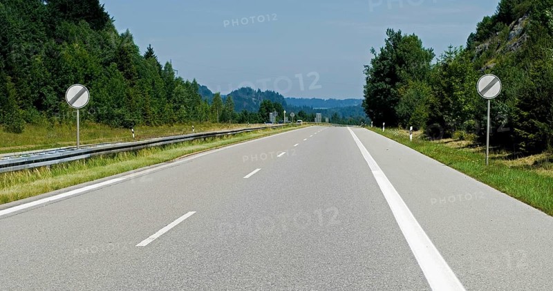 Empty Autobahn, freeway, with german traffic signs meaning speed limit cancelled, A 95 near Eschenlohe, Bavaria, Germany, Europe