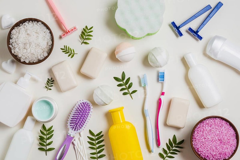 Cosmetic products with salt toothbrush razor hairbrush leaves white backdrop. Resolution and high quality beautiful photo