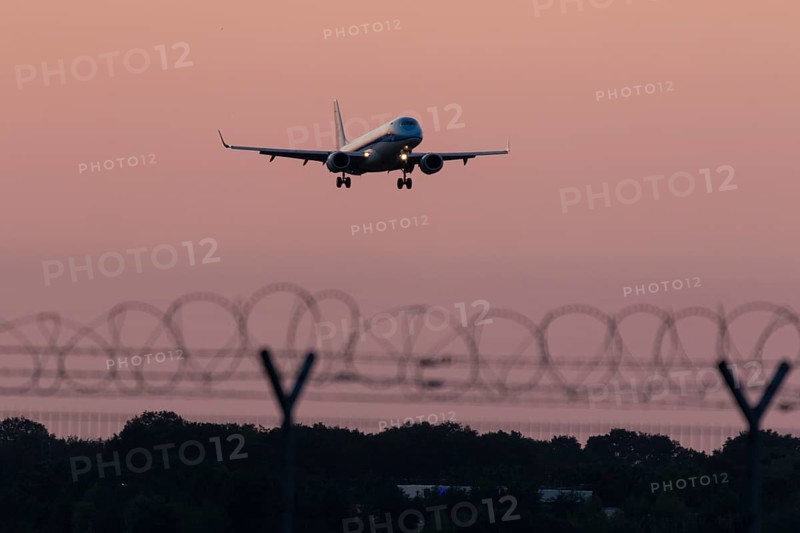 Passenger aircraft Embraer ERJ-190STD Cityhopper of the airline KLM in the sunset approaching Hamburg Airport, Hamburg, Germany, Europe
