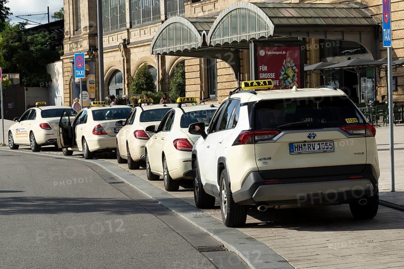 Taxis parked at a taxi rank in front of Dammtor train station in Hamburg, Germany, Europe