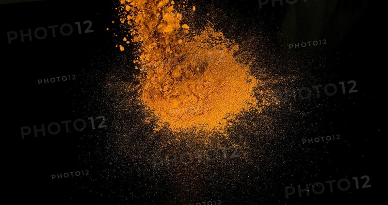Turmeric (curcuma longa), Powder Exploding against Black Background, Indian Spice