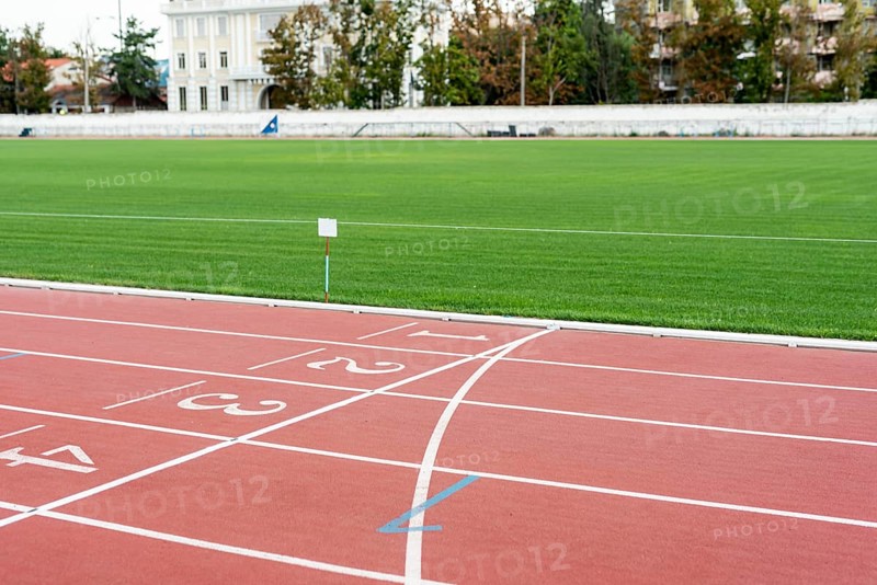Running track with grass field sunny day