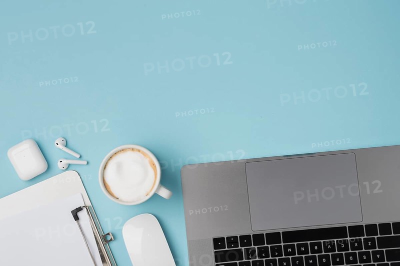 Top view desk with laptop clipboard