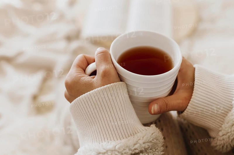 Young woman holding cup tea while enjoying winter holidays. Resolution and high quality beautiful photo
