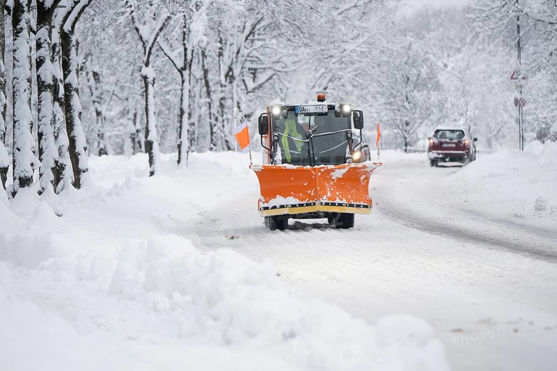 Snow plough on a snow-covered road, Daglfing, Munich, Bavaria, Germany, Europe
