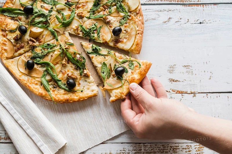 Top view hand taking slice pizza