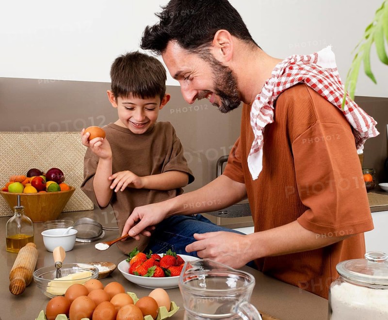 Medium shot father kid cooking together