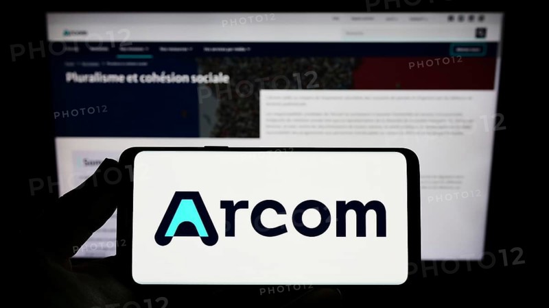 Stuttgart, Germany, 12-02-2022: Person holding smartphone with logo of French digital regulation agency ARCOM on screen in front of website. Focus on phone display, Europe